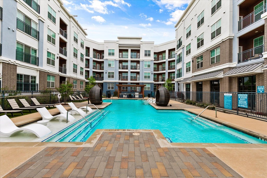 a swimming pool in front of an apartment building