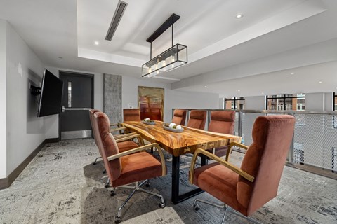 a dining room with a wooden table and leather chairs