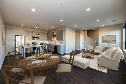 A modern kitchen with a dining table set for two.