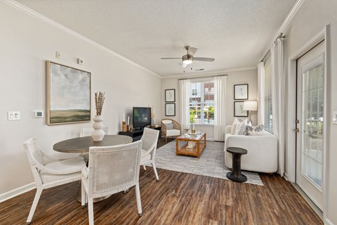A living room with a dining table and chairs.