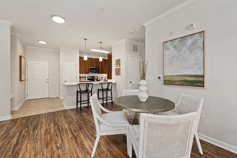 A dining room with a table and chairs.