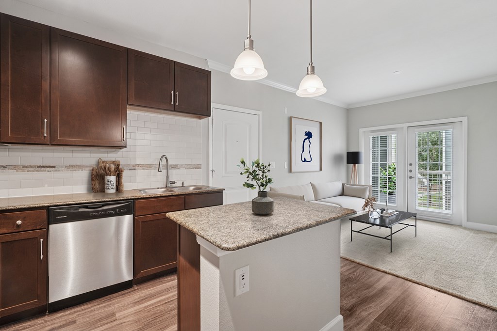 A modern kitchen with a stainless steel dishwasher and wooden cabinets.
