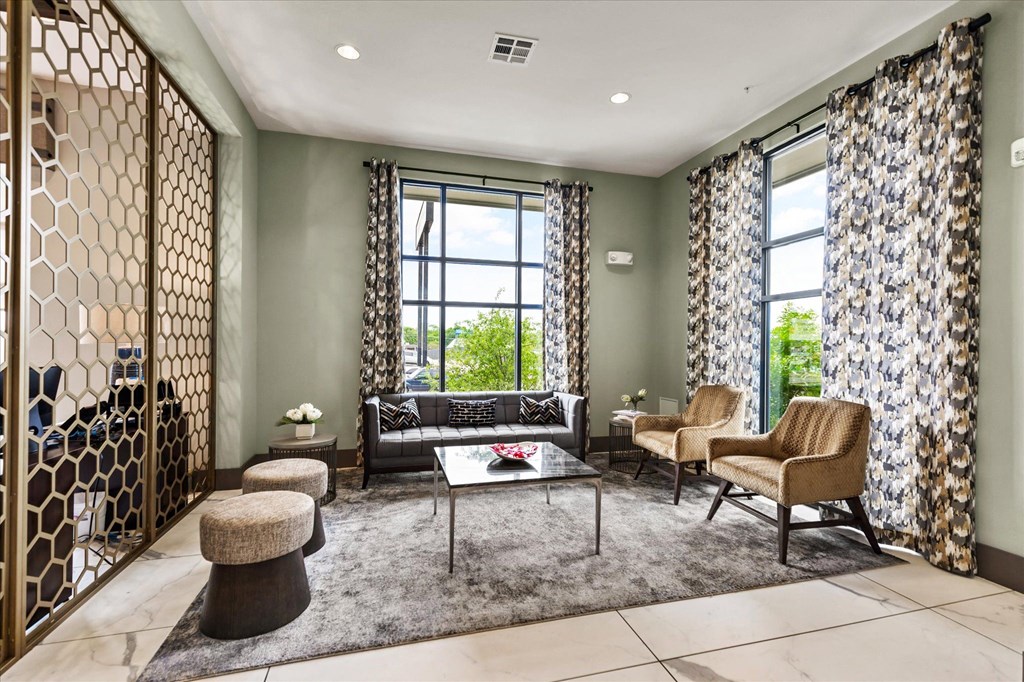 a living room filled with furniture and a large window