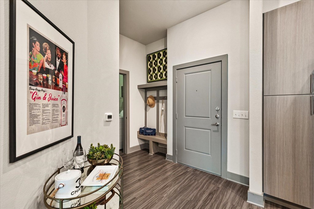 a hallway with a coffee table and a refrigerator
