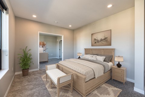 a bedroom with a bed and a chair in a room