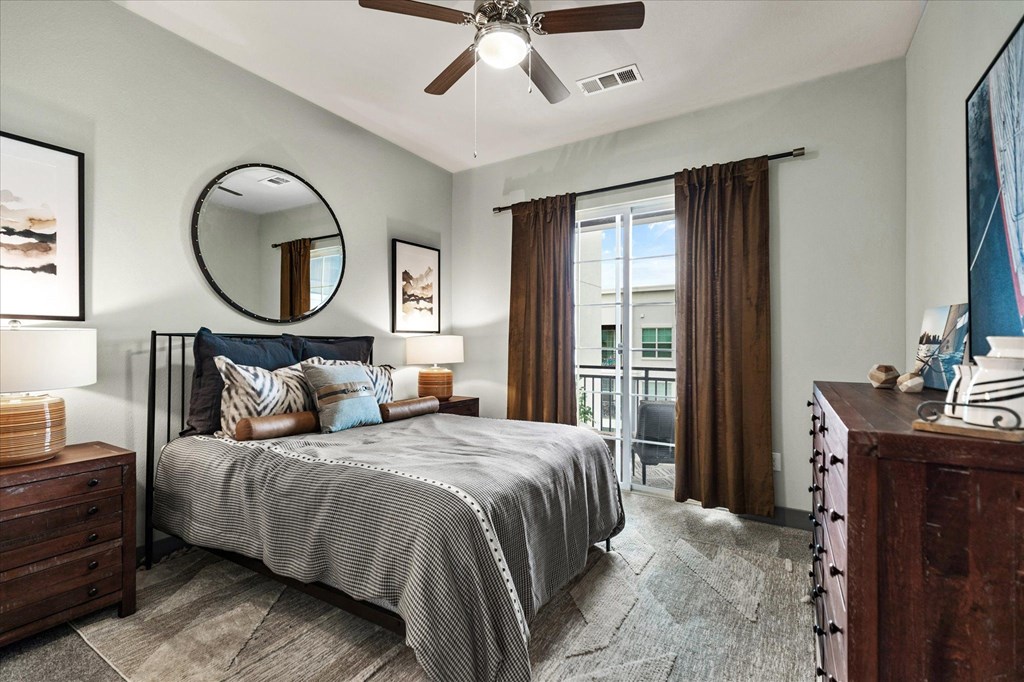 a bedroom with a bed and a ceiling fan