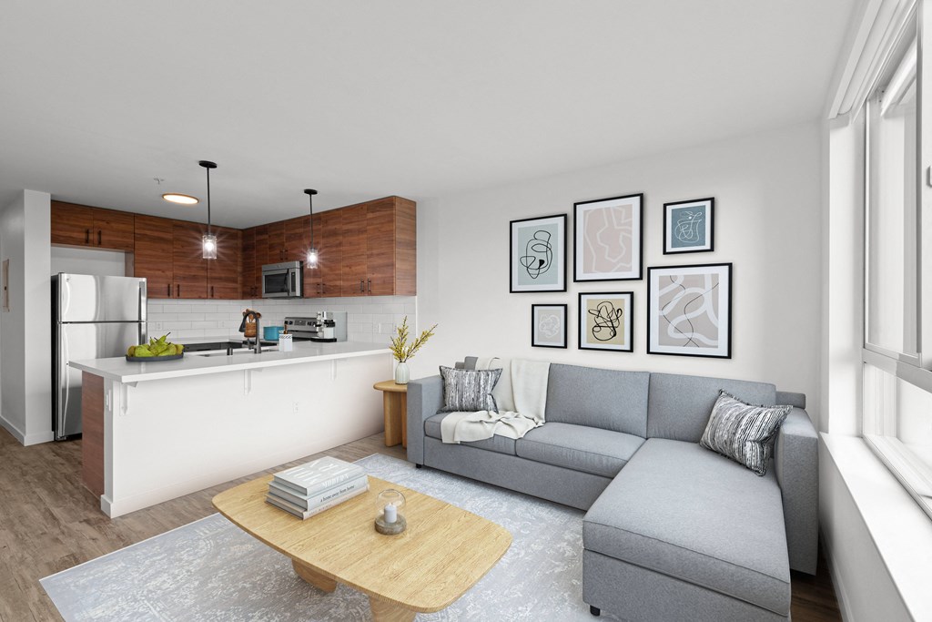 Living area with a sofa and coffee table at The Station at Othello Park South Seattle apartments