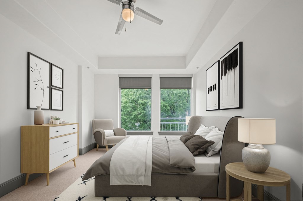 an open bedroom with a bed and a ceiling fan