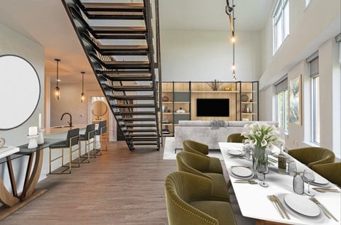 a living room with a dining room table and a staircase