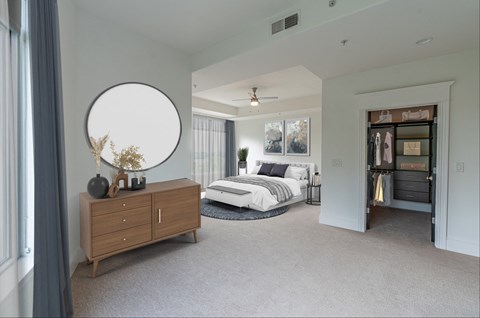 a bedroom with a bed and a dresser in a room