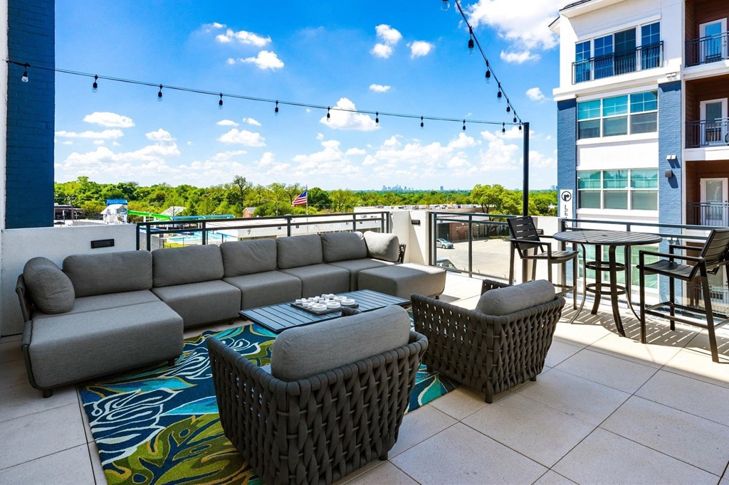 a patio with couches and chairs and a table and chairs