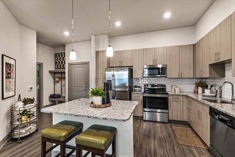 a kitchen with stainless steel appliances and granite counter tops