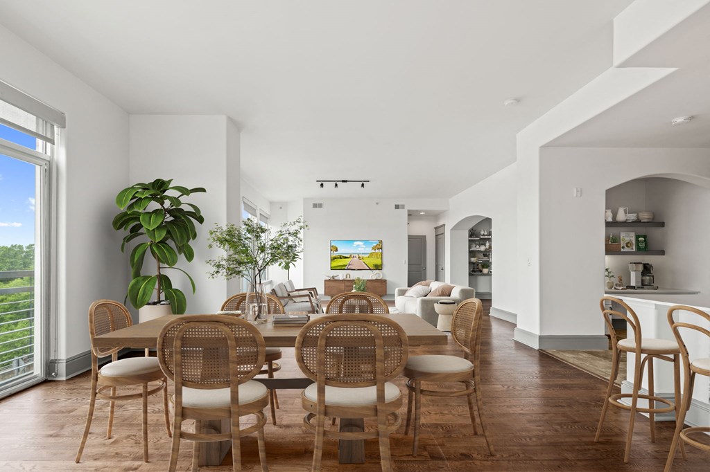 a dining room with a wooden table and chairs
