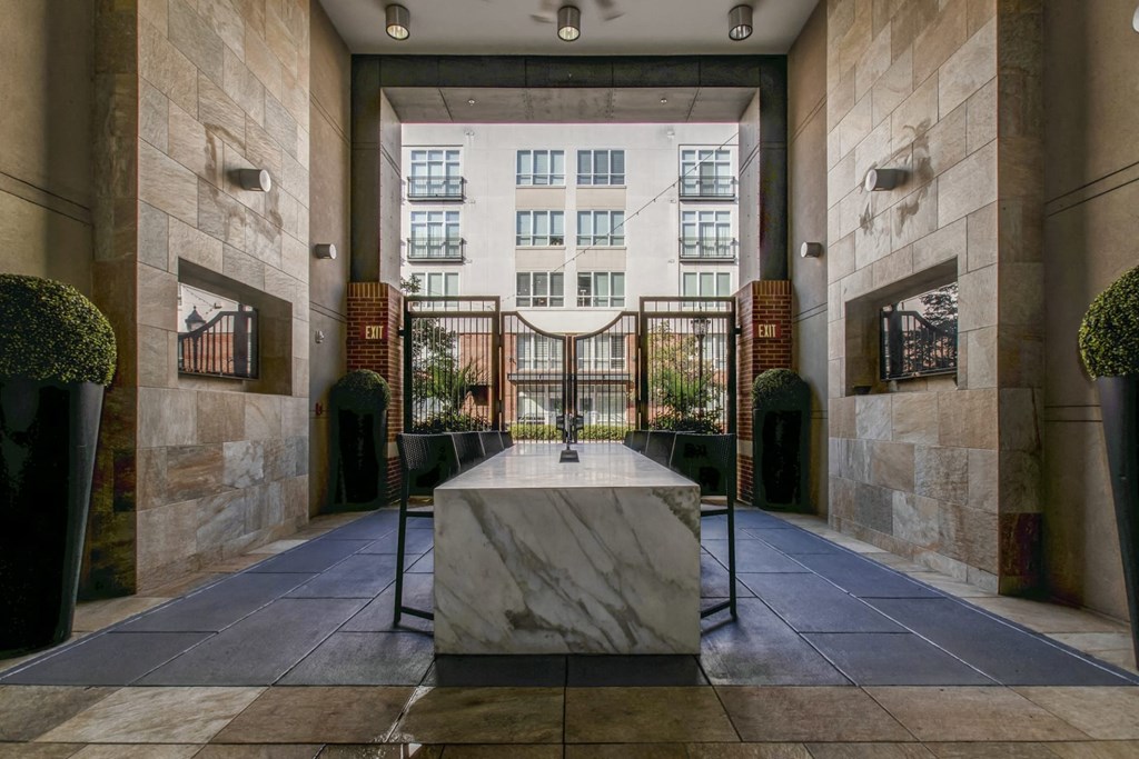 a marble table in the lobby of a building with a large window