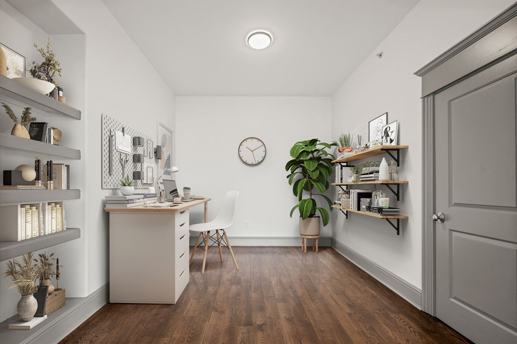 a home office with a desk and a clock on the wall
