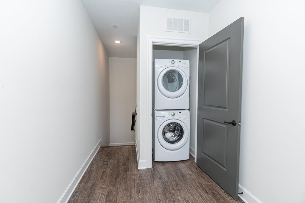 a white washer and dryer in a room with a door
