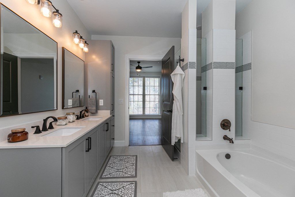 a bathroom with a tub and a sink and a shower