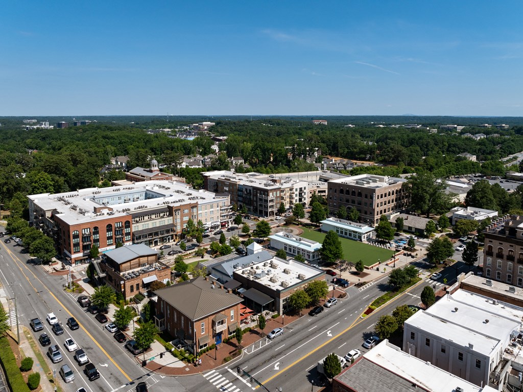 an aerial view of a city with buildings and trees