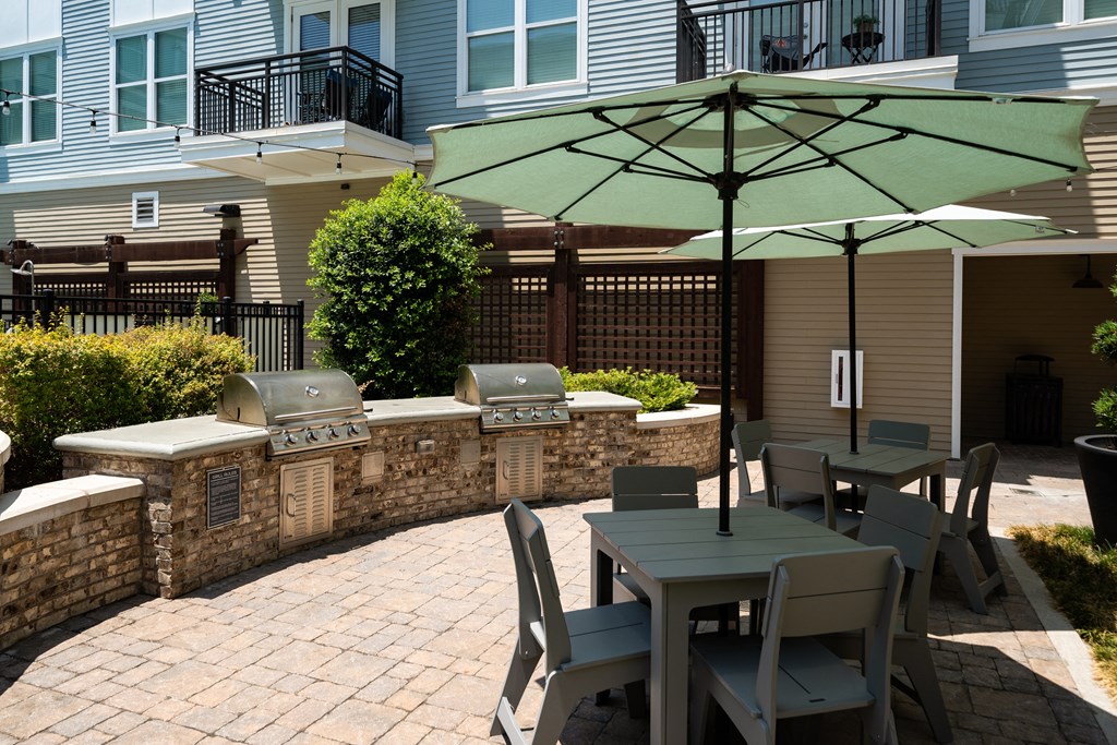 a patio with tables and chairs and umbrellas