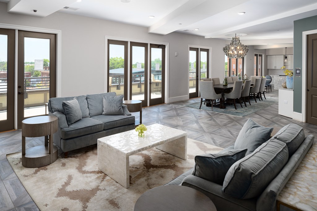 a living room and dining room with couches and a table