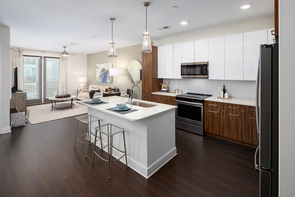 a large kitchen with a center island and stools