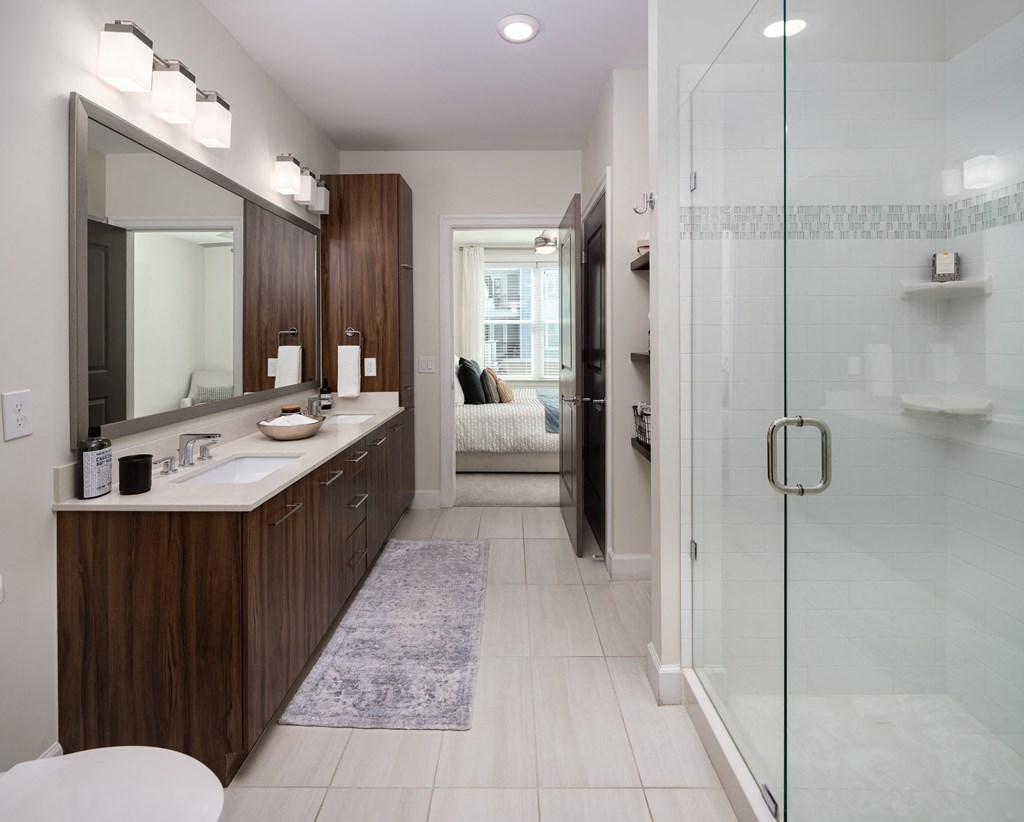 a bathroom with a shower and a sink and a mirror
