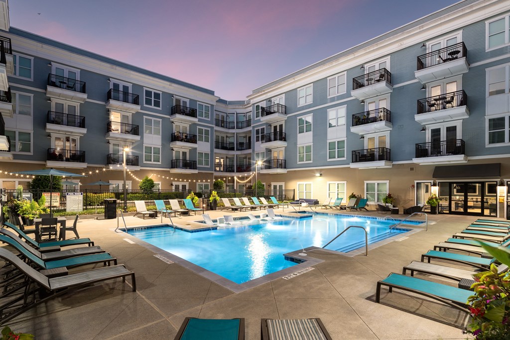 a swimming pool in an apartment building at night