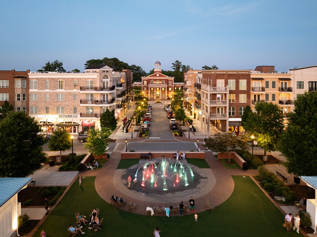 an aerial view of a fountain in the middle of a city square