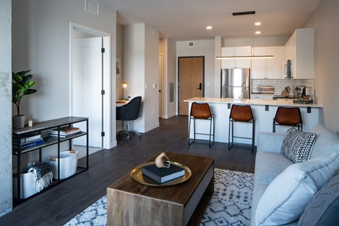 A modern living room with a coffee table in the center.