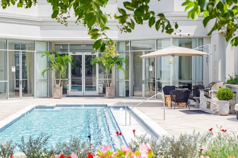 a view of the pool and the house from the garden