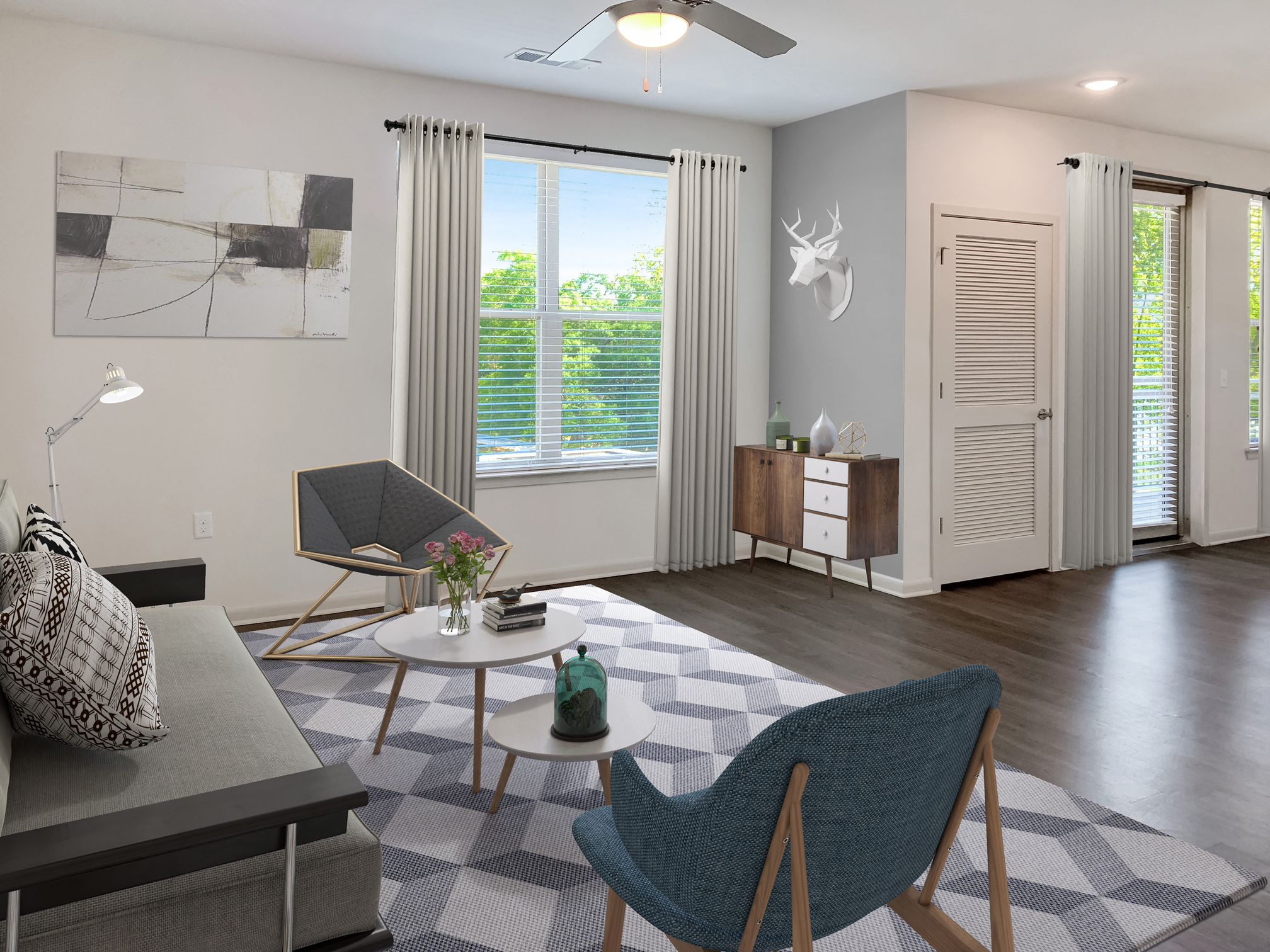 a living room with a couch and chairs and a table