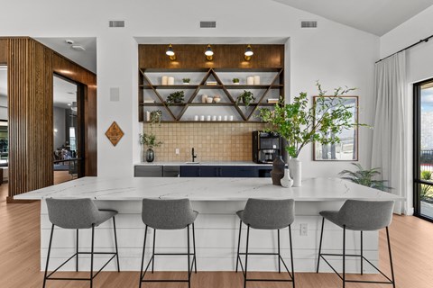 a kitchen with a marble counter top and bar stools