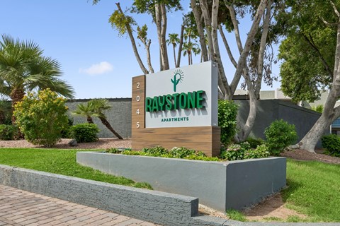 A sign for Day's Stone Spa is displayed in front of a landscaped area.