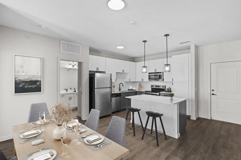 an open kitchen and dining room with a table and chairs