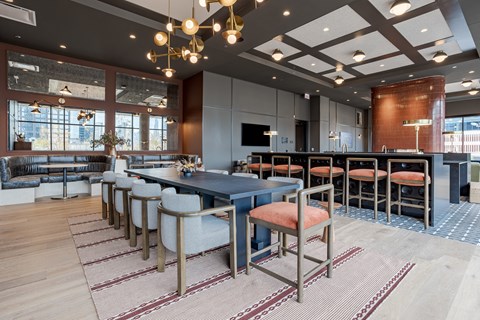 A modern dining area with a long table and chairs.