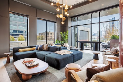 A modern living room with a large sectional sofa and a coffee table.
