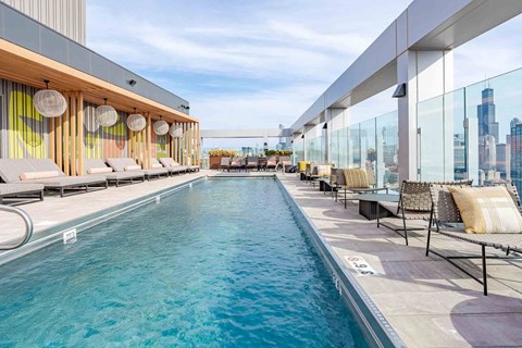 A long rectangular pool with a glass barrier on one side.