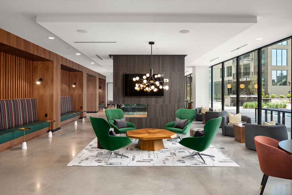 a large lobby with a table and chairs and a television