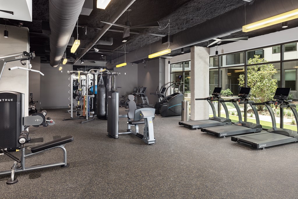 a gym with treadmills and other exercise equipment in a building