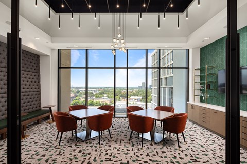 a dining room with a table and chairs in front of a window