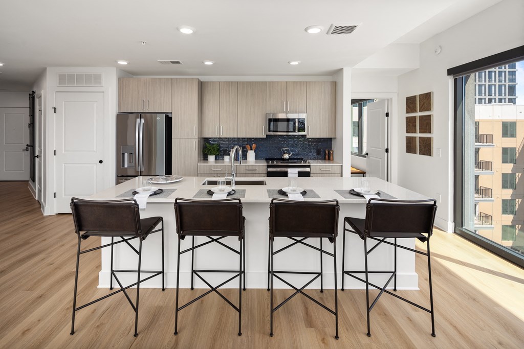a kitchen with a large island with bar stools