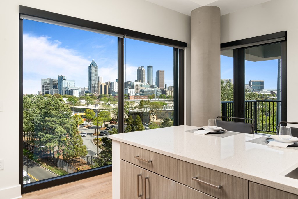 a view of the city skyline from a bathroom with a large window