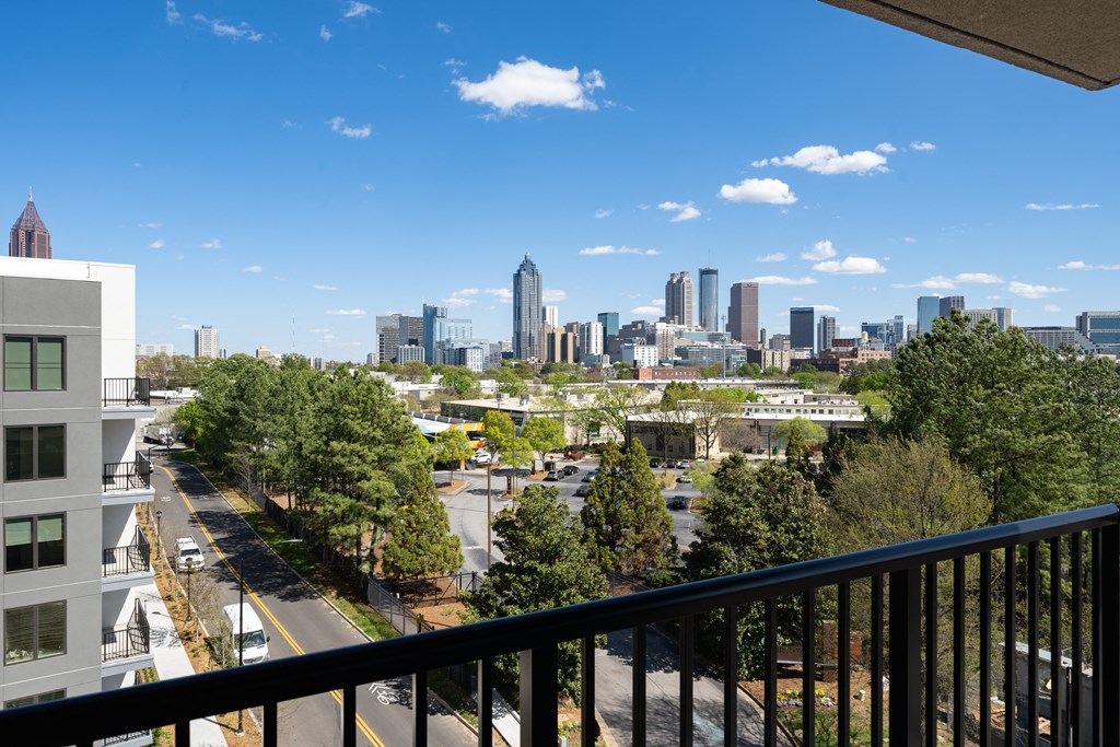 the view of the city from the balcony of a condo