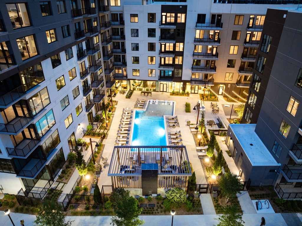 an overhead view of an apartment building with a swimming pool