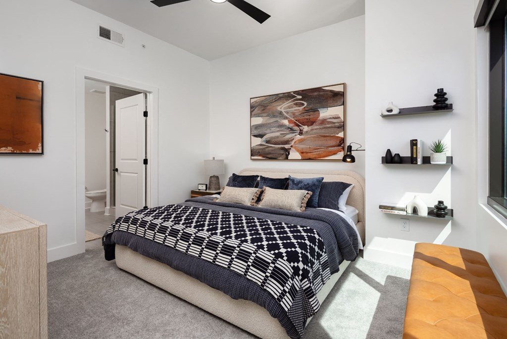 a bedroom with a bed and a ceiling fan