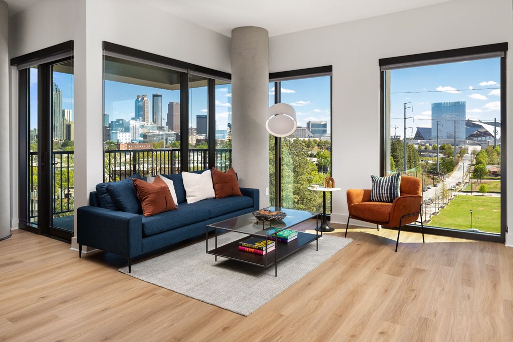a living room with a couch and a coffee table and a view of the city