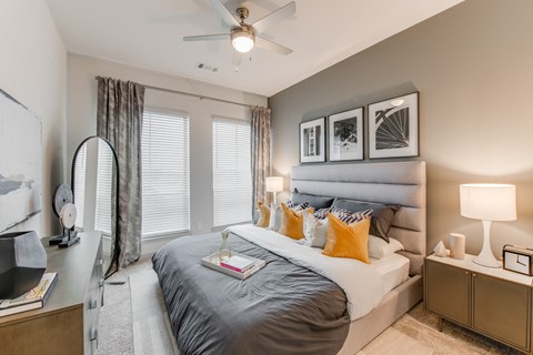 a bedroom with a large bed and a ceiling fan