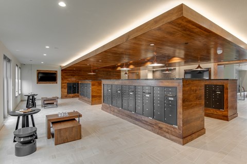 the locker room at the gym has a large locker area with benches and stools
