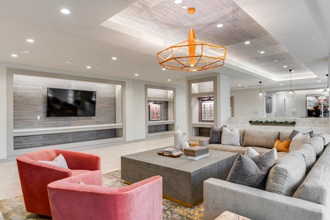 a large living room with couches and a tv