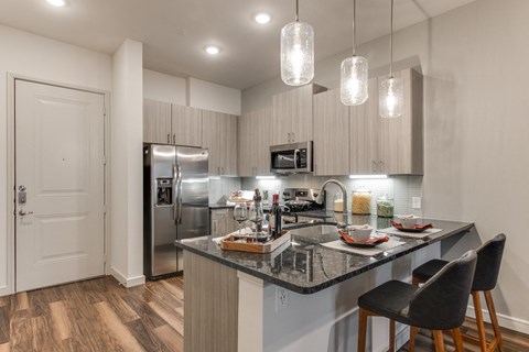 a kitchen with granite counter tops and stainless steel appliances